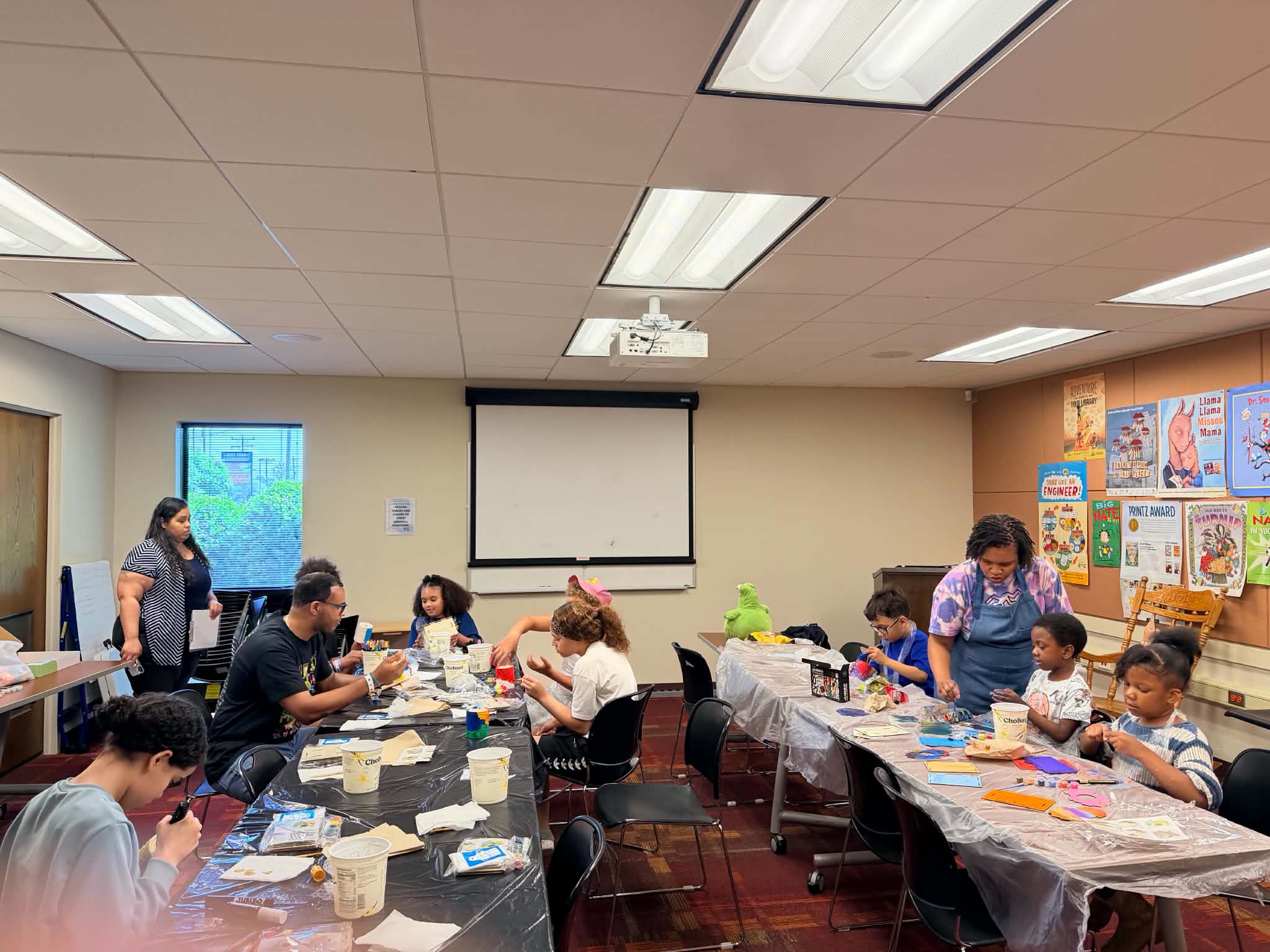 Participants gathered around tables during a Rising Up Now art workshop.