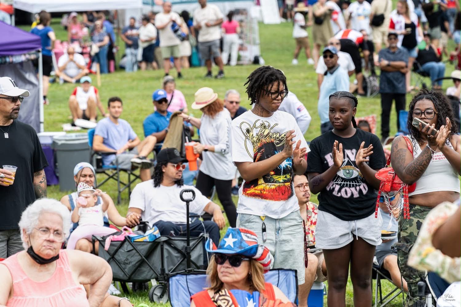 Audience members clap and watch a performance during the Puerto Rican Festival.