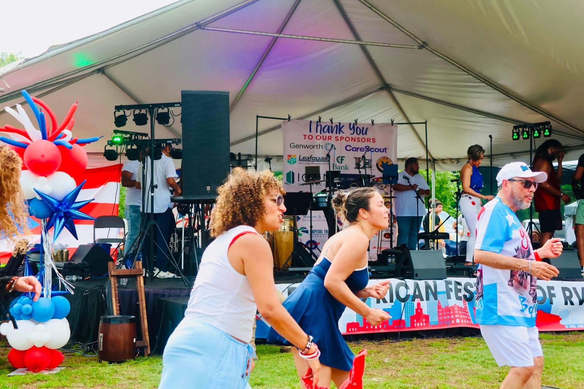 Festival attendees dance in front of the stage during a Puerto Rican Festival performance.