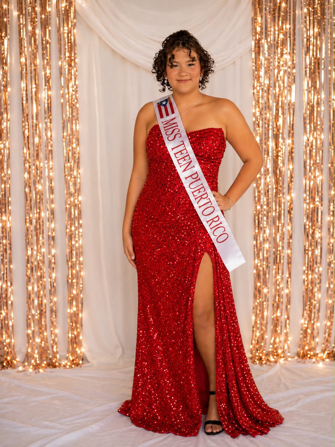 A formal portrait of Miss Teen Puerto Rico wearing a red gown and sash.