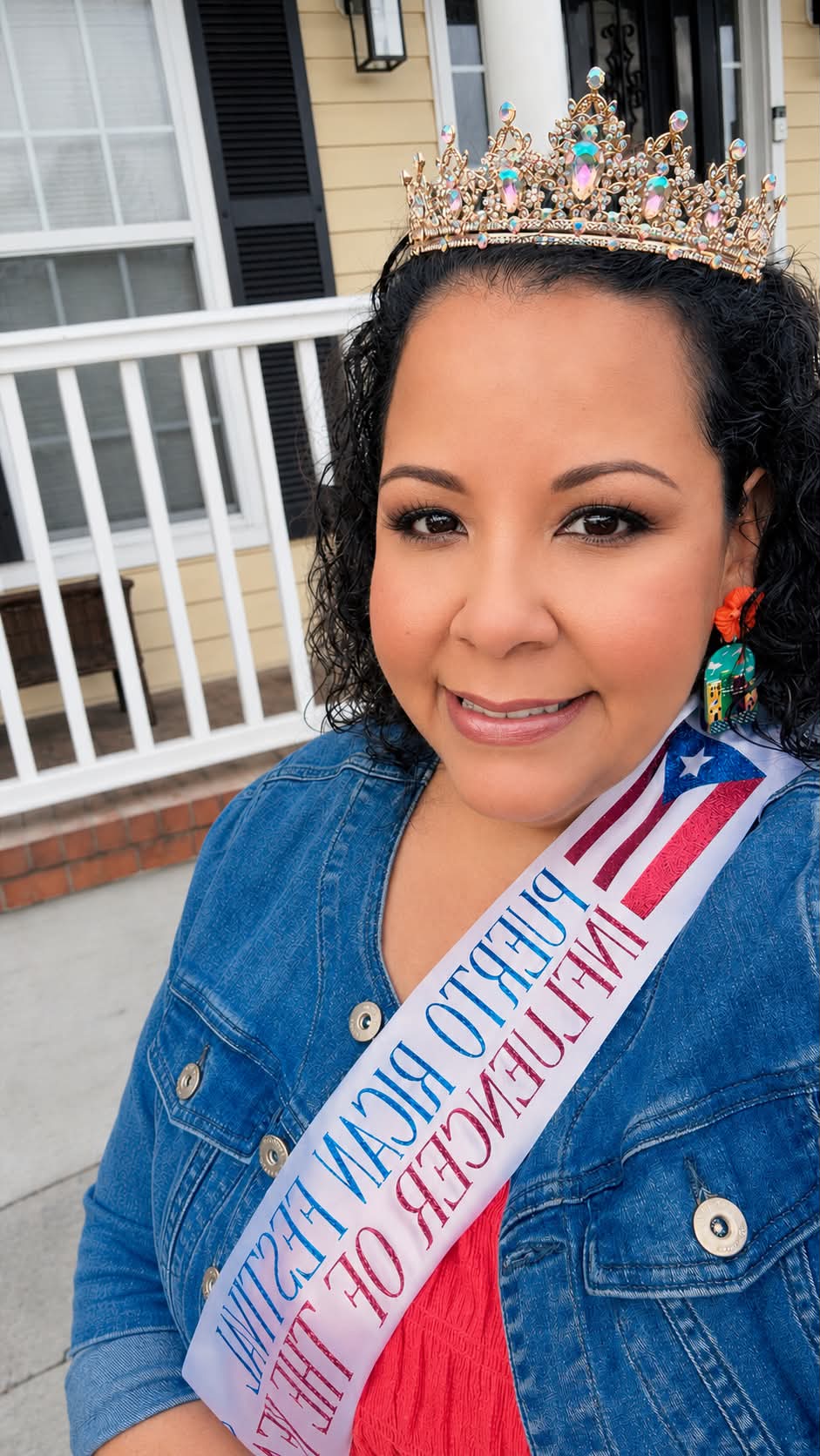 A portrait of the Puerto Rican Festival queen wearing a sash and crown.